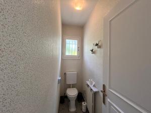a small bathroom with a toilet and a window at Appartement T3 centre-ville avec jardin et climatisation - FR-1-541-132 in La Roche-Posay +10 photos