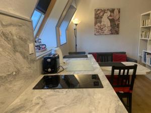 a kitchen with a counter top and a living room at Appartement lumineux avec climatisation et WIFI, proche des Thermes St Roch - FR-1-541-128 in La Roche-Posay +3 photos