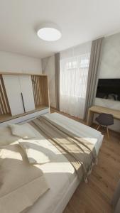 a bedroom with a large bed in a room at COZY CENTRAL Apartment in Dolný Kubín