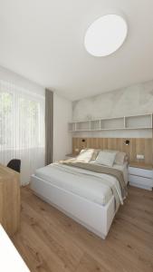a white bedroom with a large bed and a table at COZY CENTRAL Apartment in Dolný Kubín +56 photos
