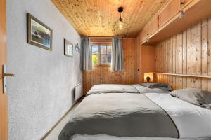 a bedroom with two beds and a wooden ceiling at Eole - 6 pers - pres des pistes in Nendaz