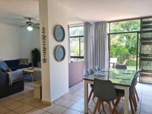 a dining room and living room with a table and chairs at Riverglades 1 in Margate
