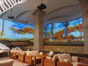 a lobby with a large painting on the wall at Songdo Central Park Hotel in Incheon
