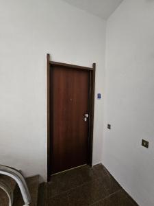 a brown door in a room with white walls at La Darsena Guesthouse Room 1 - by Be Your Home in Civitavecchia