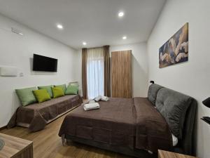 a living room with a bed and a couch at La Darsena Guesthouse Room 1 - by Be Your Home in Civitavecchia