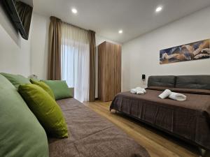 a bedroom with two beds and a couch at La Darsena Guesthouse Room 1 - by Be Your Home in Civitavecchia +23 photos