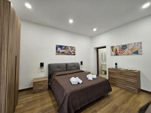 a bedroom with a bed with two towels on it at Be Your Home - La Darsena Guest House in Civitavecchia