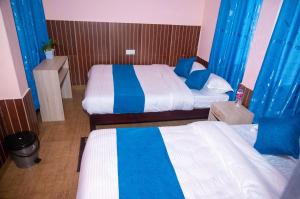 Łóżko lub łóżka w pokoju w obiekcie Hotel White Yak