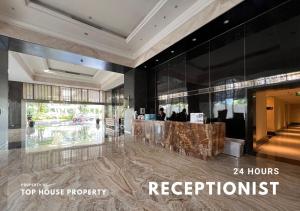 a lobby of a hotel with a reception desk at 2 Bed Casa Grande Mall Kota Kasablanka By Travelibu in Jakarta +27 photos