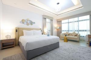 a bedroom with a large white bed and a couch at Roda Beach Resort in Dubai +66 photos