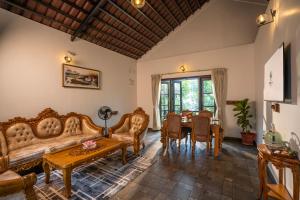 a living room with a couch and a table at Regenta Resort Mysore Tropical Village in Chāmundi