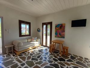 a living room with a couch and a table at Dendrinos studio in Galissas