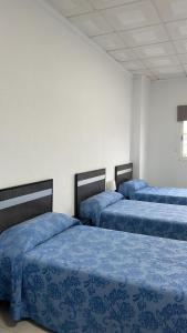 Postel nebo postele na pokoji v ubytování Hostal Kaizen