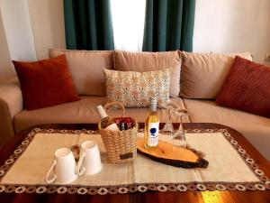 a living room with a couch with a table with wine bottles at Dvata Smurcha Central Apartments - Free Parking in Bansko