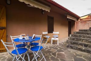 a blue table and chairs on a patio at Casa relax tra cielo e mare in Bosa