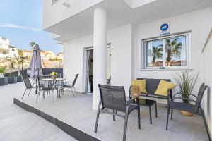 a patio with chairs and a table on a balcony at Sungolfbeach El Girasol in Orihuela