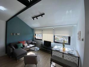 a living room with a couch and a table at Skade Sierra Nevada Zona Baja in Sierra Nevada