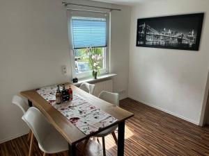 a dining room with a table and chairs and a window at Ferienwohnung in Alpirsbach in Alpirsbach