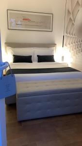 a large bed in a room with a bed sidx sidx sidx at Rossodisera in Sarzana