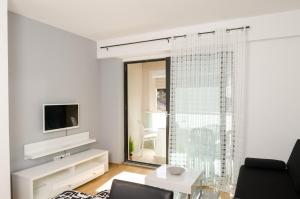 a living room with a couch and a tv at Apartment Atlant in Dubrovnik