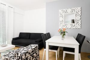 a living room with a black couch and a table at Apartment Atlant in Dubrovnik