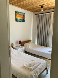 a hotel room with two beds and a window at Magnificent sunset view in Fethiye +47 photos