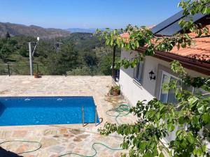 a house with a swimming pool next to a building at Magnificent sunset view in Fethiye
