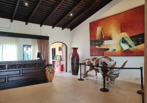 a room with vases and art on the walls at Marenaz Oceanfront Resort in Esterillos Este