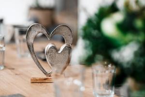 a metal heart sitting on top of a wooden table at Shared-LiveWork Suites in Kempten