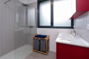 a bathroom with a sink and a glass shower at Grande maison bord de Mer in Sarzeau +17 photos