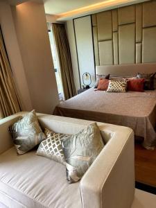 a living room with two beds and a couch at Apartment in Mida Grande Surin in Ban Lum Fuang +16 photos