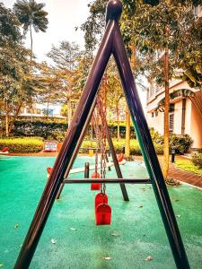 a swing set in a park with a playground at Natural Haven at South in Manila