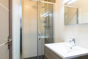 a bathroom with a sink and a shower at Unsejouranantes - Gîte Lamoricière in Nantes +17 photos