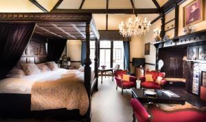 a bedroom with a large bed and a chandelier at Langtry Manor Hotel in Bournemouth