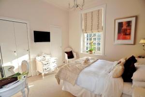 a bedroom with a bed with two dogs laying on it at Langtry Manor Hotel in Bournemouth