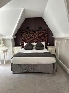 a bedroom with a large bed in a attic at Langtry Manor Hotel in Bournemouth