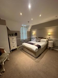 a bedroom with a large bed and a window at Langtry Manor Hotel in Bournemouth