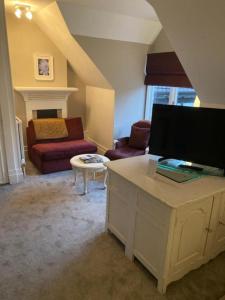 a living room with a couch and a table at Langtry Manor Hotel in Bournemouth