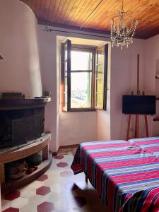 a bedroom with a bed and a fireplace and a window at Tabernacolo in Carpineta