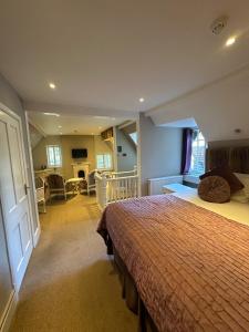 a bedroom with a bed and a living room at Langtry Manor Hotel in Bournemouth