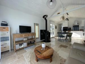a living room with a couch and a table at TI KAZ - Terrasse extérieure - 5mn Plage in Pleubian +26 photos
