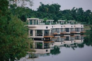 a house on a lake with its reflection in the water at Lamori Resort & Spa, Thanh Hoá in Thanh Hóa +159 photos