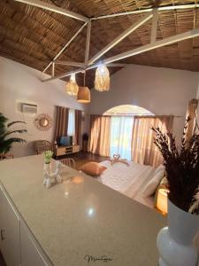 a kitchen and living room with a bed in a room at Manawari Beach Resort in Caliclic