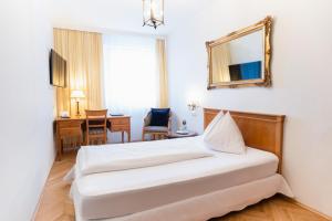 Rúm í herbergi á Austria Classic Hotel Wolfinger - Hauptplatz