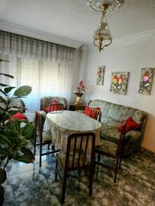 a living room with a table and chairs and a couch at casa el chiquitín in La Zubia