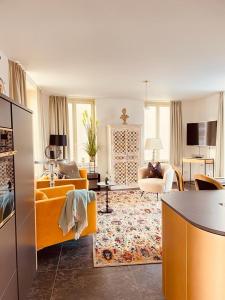 a living room with a yellow couch and a table at Penthouse Traum - Blick über Arnstadt in Arnstadt
