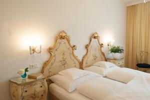 Rúm í herbergi á Austria Classic Hotel Wolfinger - Hauptplatz