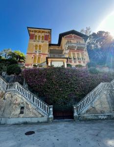 a large building with a staircase in front of it at Villa fronte mare in Levanto
