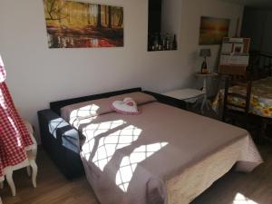 a bedroom with a bed with a pair of shoes on it at La Casa del Borgo-intero appartamento in Latina