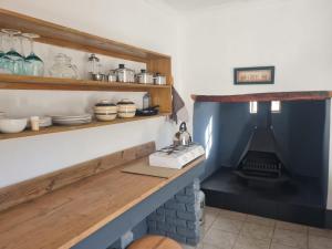 a kitchen with a counter and a stove in a room at Landsrivier Cottage No 1 in Uniondale +22 photos